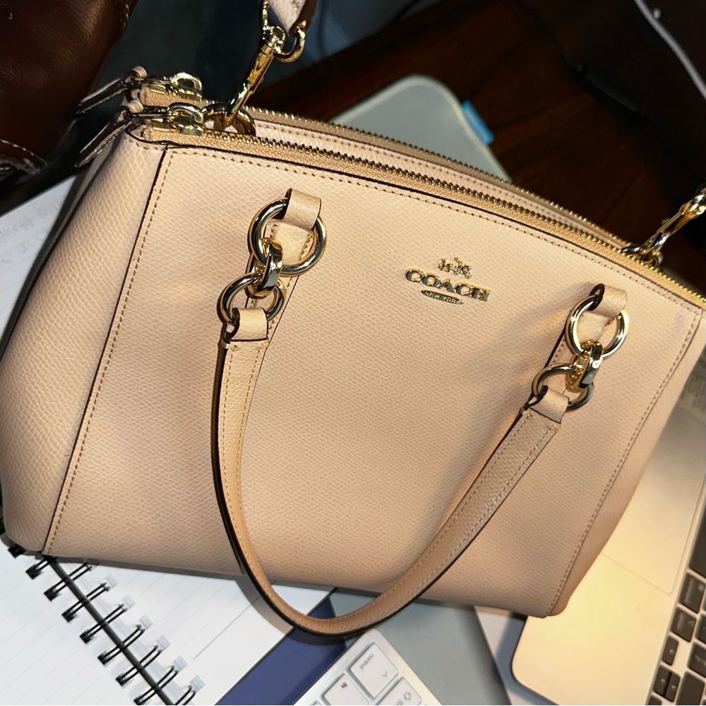 Coach Mini Christie crossbody with detachable strap and matching wallet set.